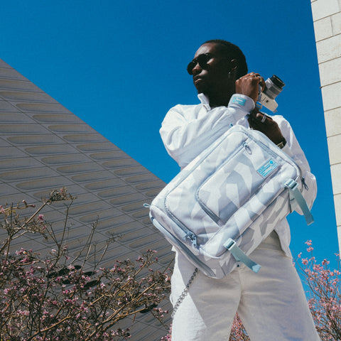 Man holding the Ranger DSLR Sling XL Arctic Camo