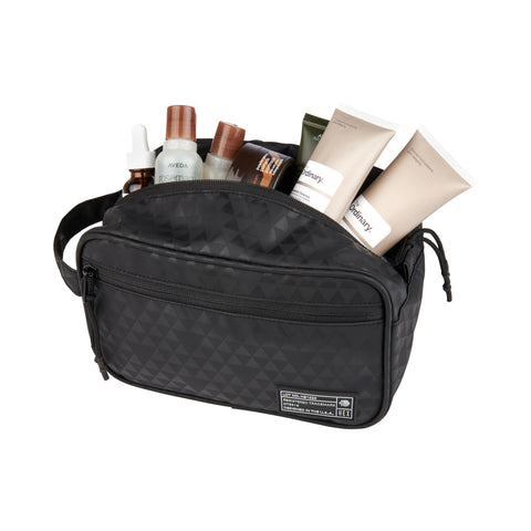 HEX Aspect Black Triangle Dopp Kit, shown with skin care products