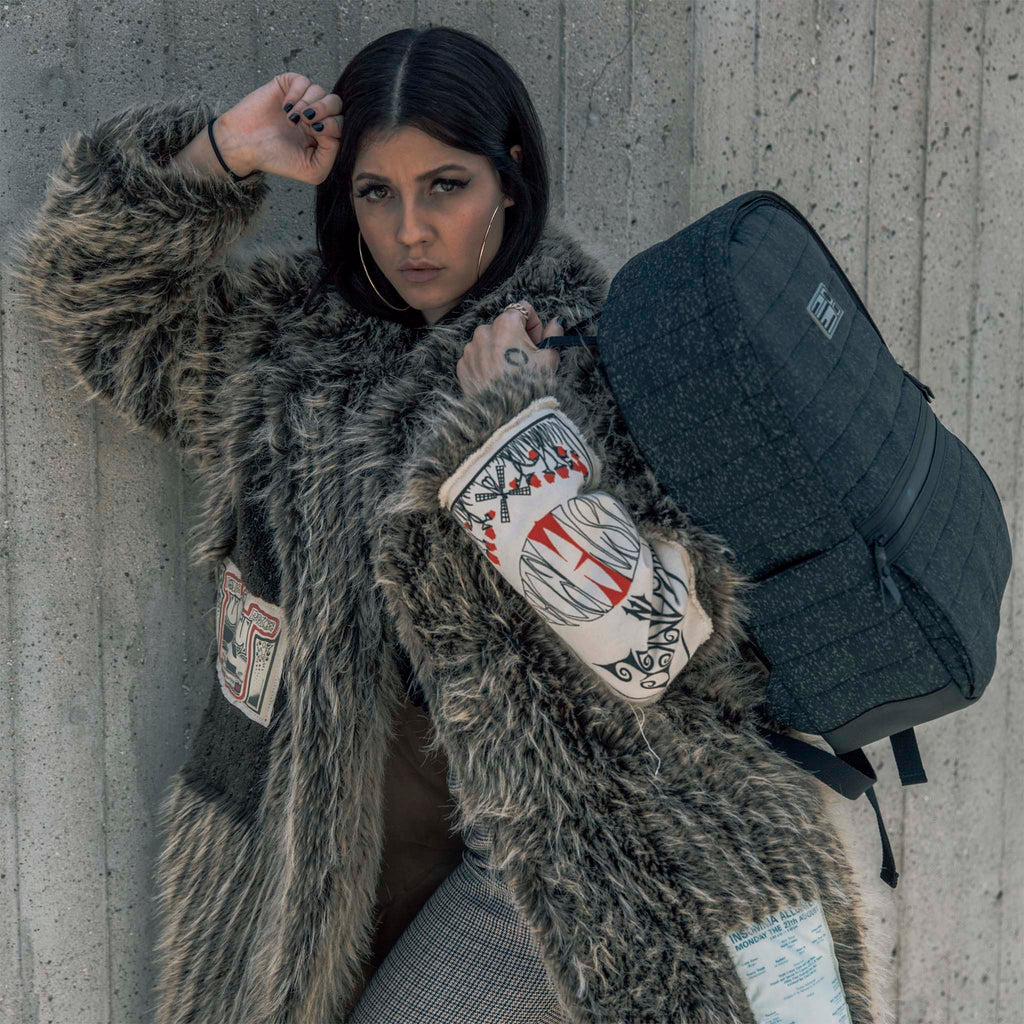 Woman wearing HEX Galaxy Black Reflective Logic Backpack