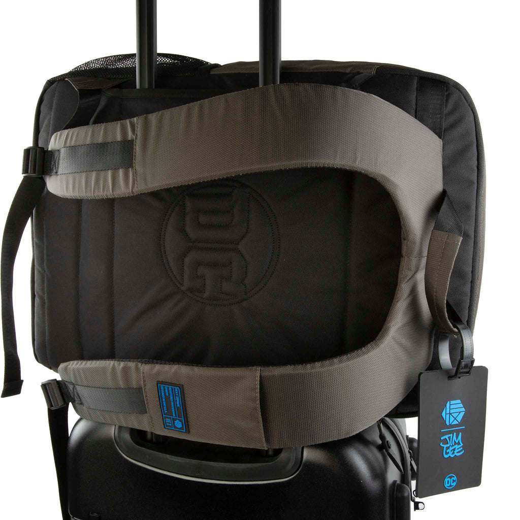 Close up of HEX x Jim Lee Artist Backpack, showing pass-through for rolling luggage handle