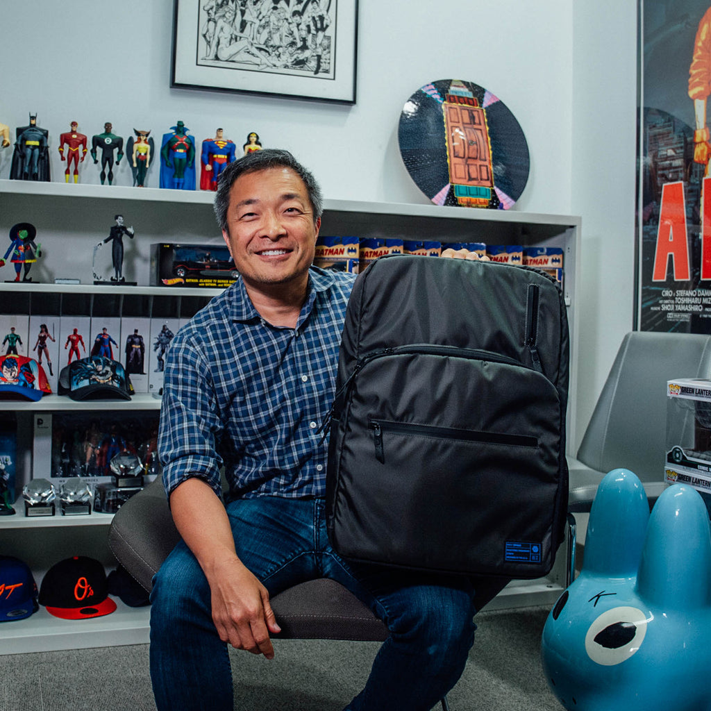 Jim Lee holding the HEX x Jim Lee Artist Backpack