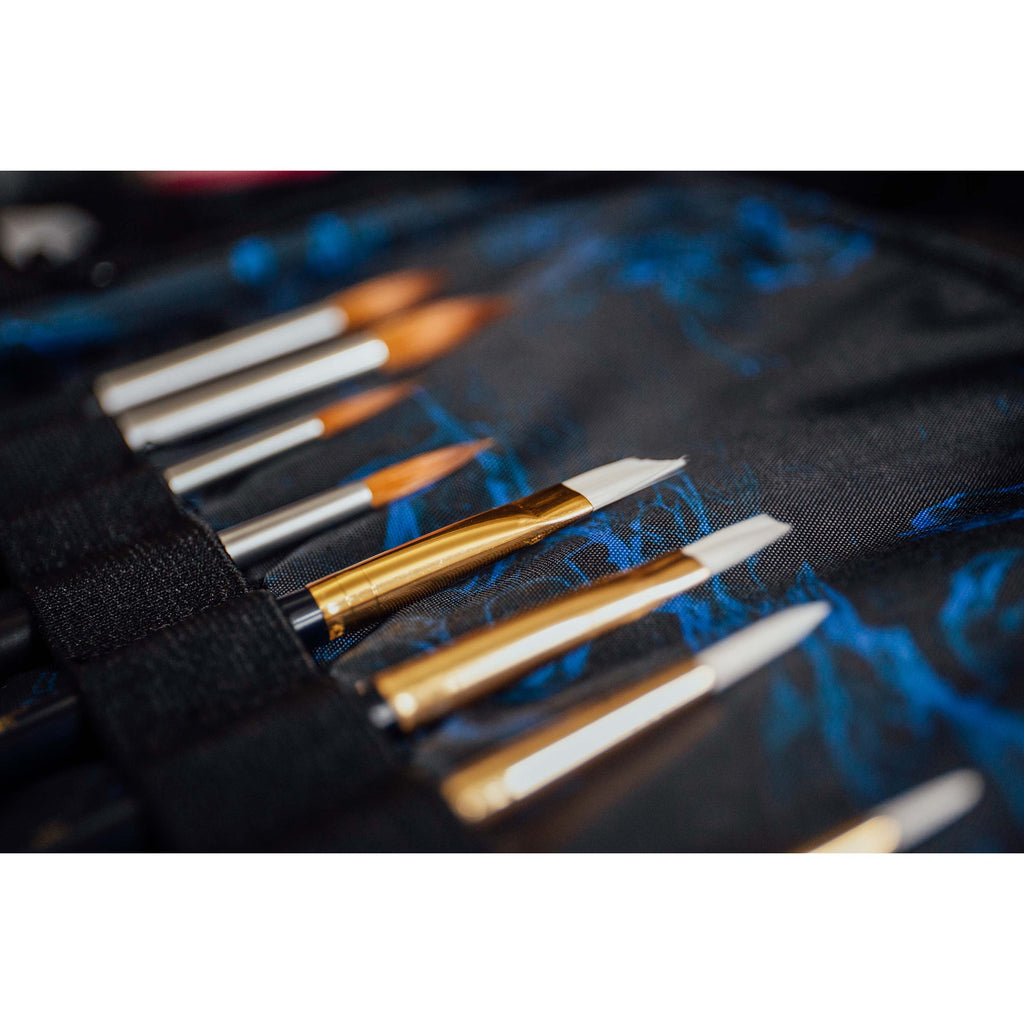 Close up of HEX x Jim Lee Artist Backpack, showing art supplies stored in pack