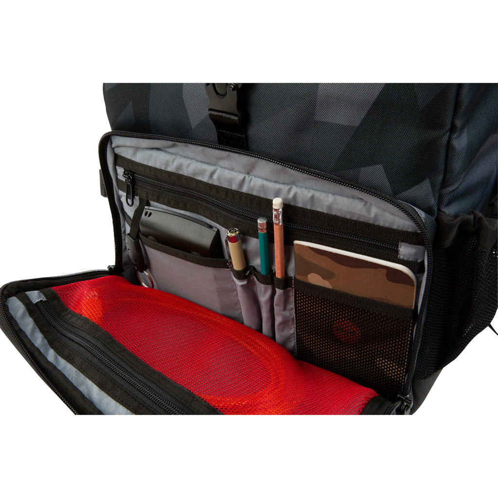 Inside view of the Hex Glacier Camo Back Loader DSLR Backpack accessory pocket showing a phone, tablet, and other accessories stored