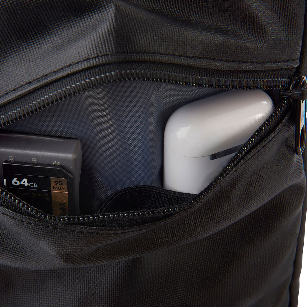 Close up of HEX Ranger Crossbody Blackout Camo, showing small accessories in storage pocket