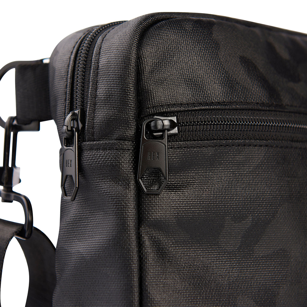 Close up of HEX Ranger Crossbody Blackout Camo, showing custom black HEX zipper pulls