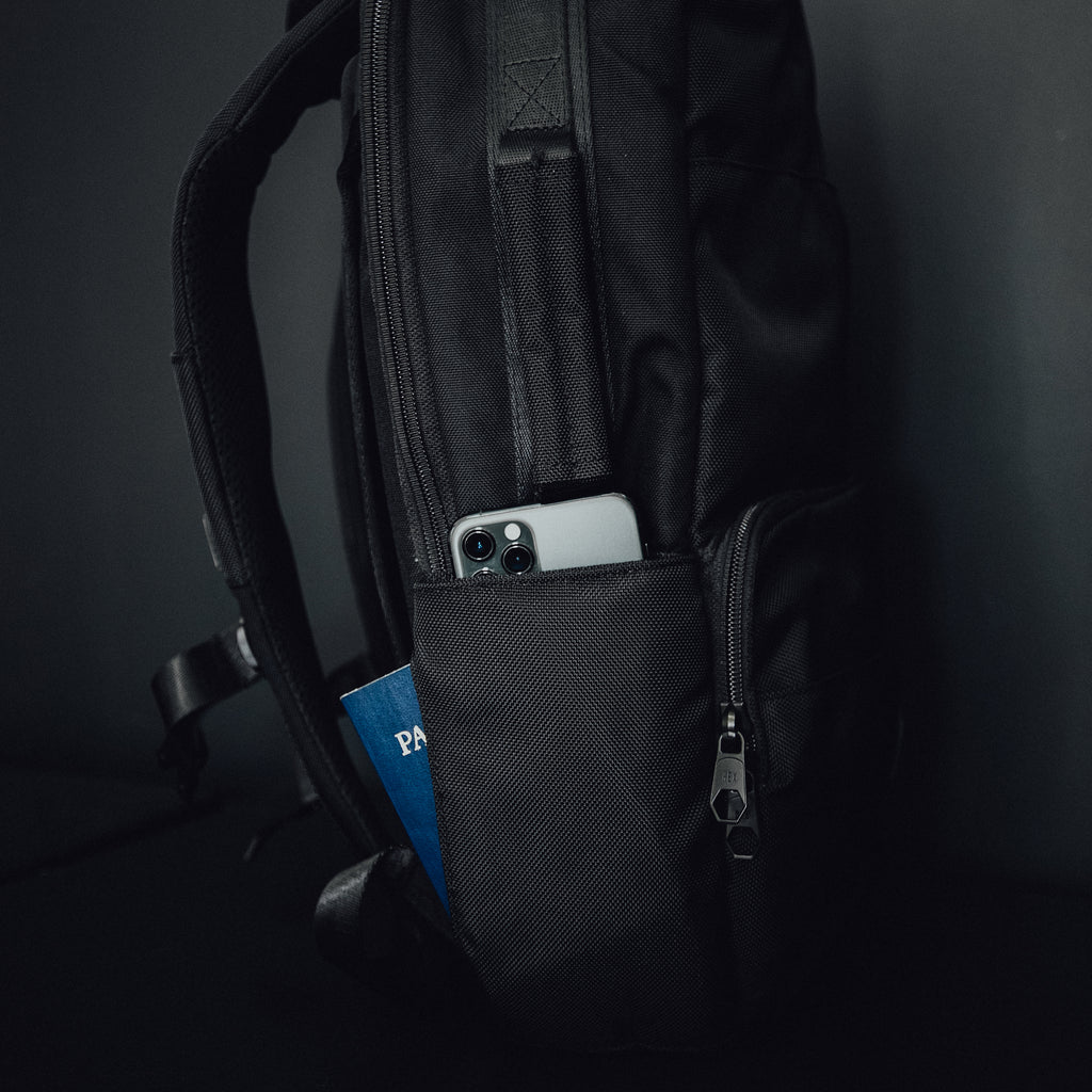 HEX Technical Backpack Glacier Camo, side view, showing phone in pocket