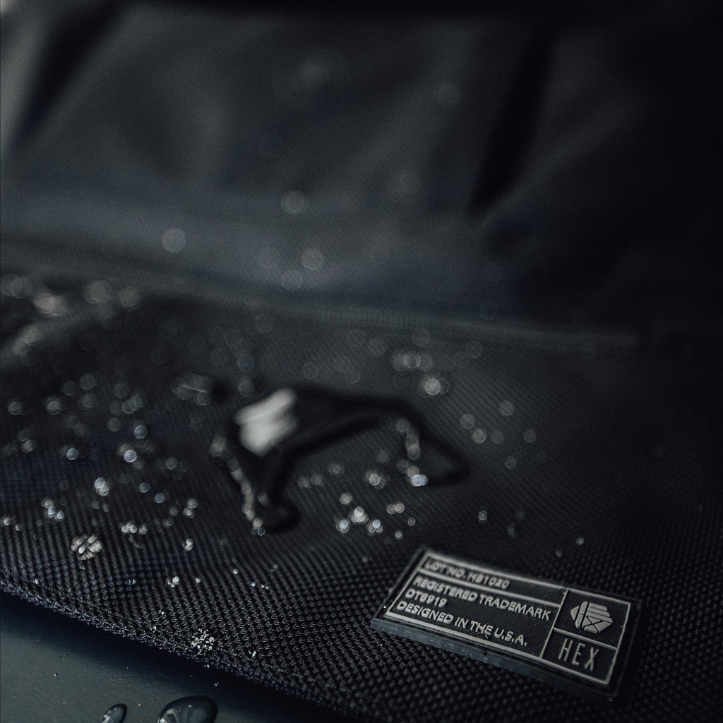 Close up of HEX Technical Backpack Glacier Camo, showing HEX label